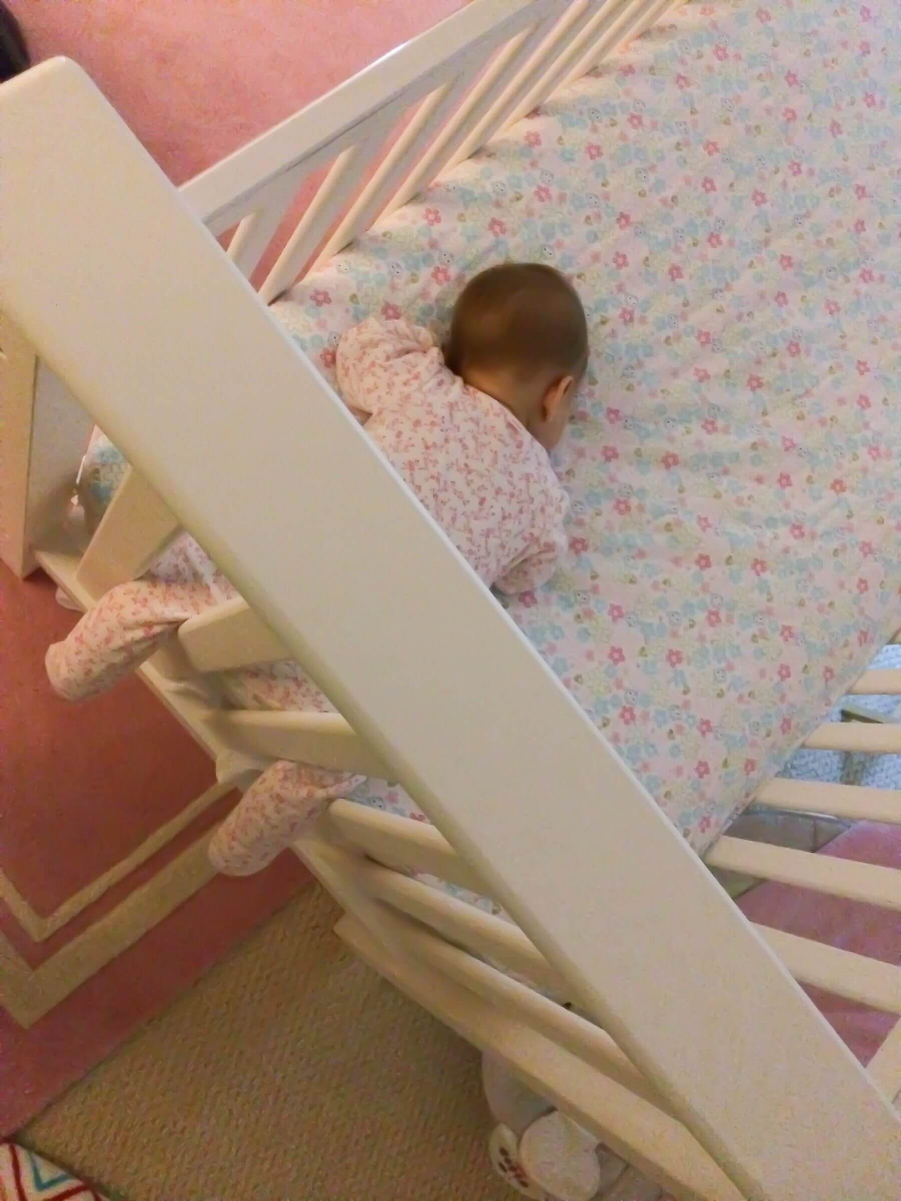 baby bangs head on cot