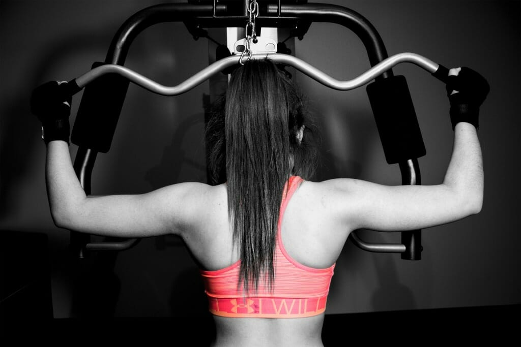 Female athlete training lats