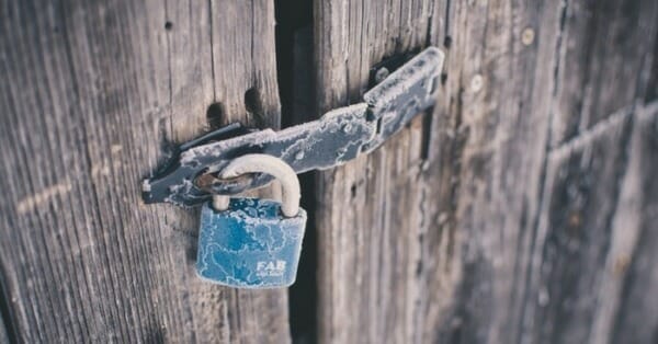 frozen padlock on wooden door