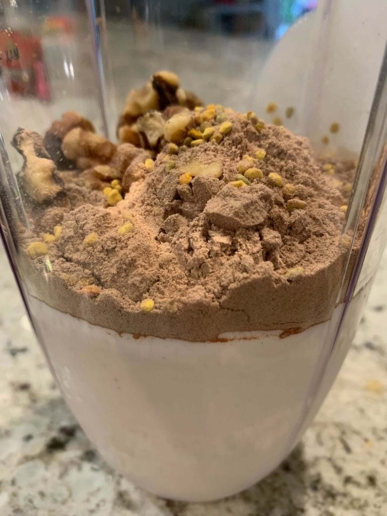 Post-workout shake with protein powder, walnuts, bee pollen and almond yoghurt.