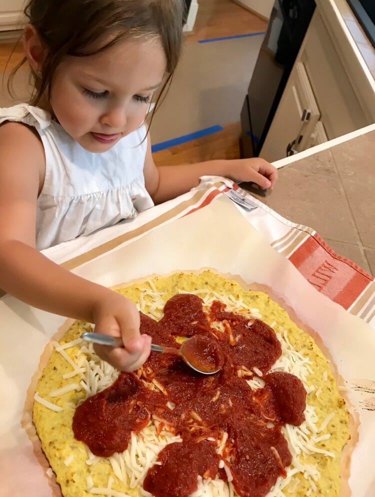 Isabella preparing a cauliflower-crust pizza