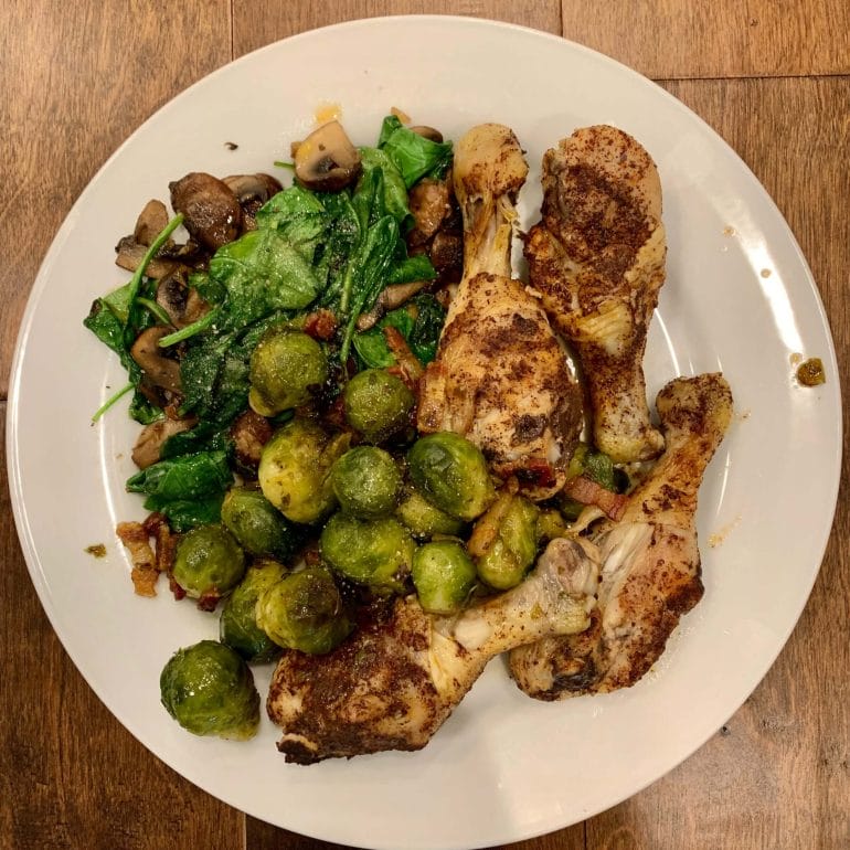 Chicken thights with brussels sprouts, mushrooms, spinach and bacon