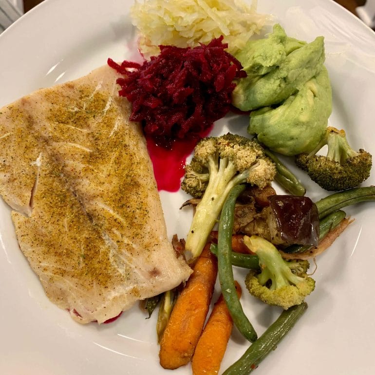 Steamed fish with carrots, broccoli, green beans, eggplant, sauerkraut, fermented beets and guacamole