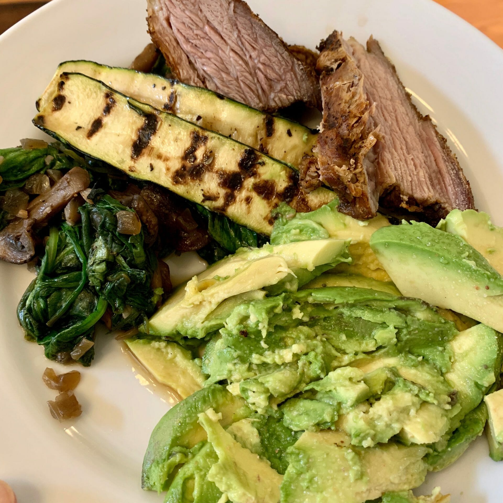 Brisket with grilled zucchini, avocado, spinach and mushrooms