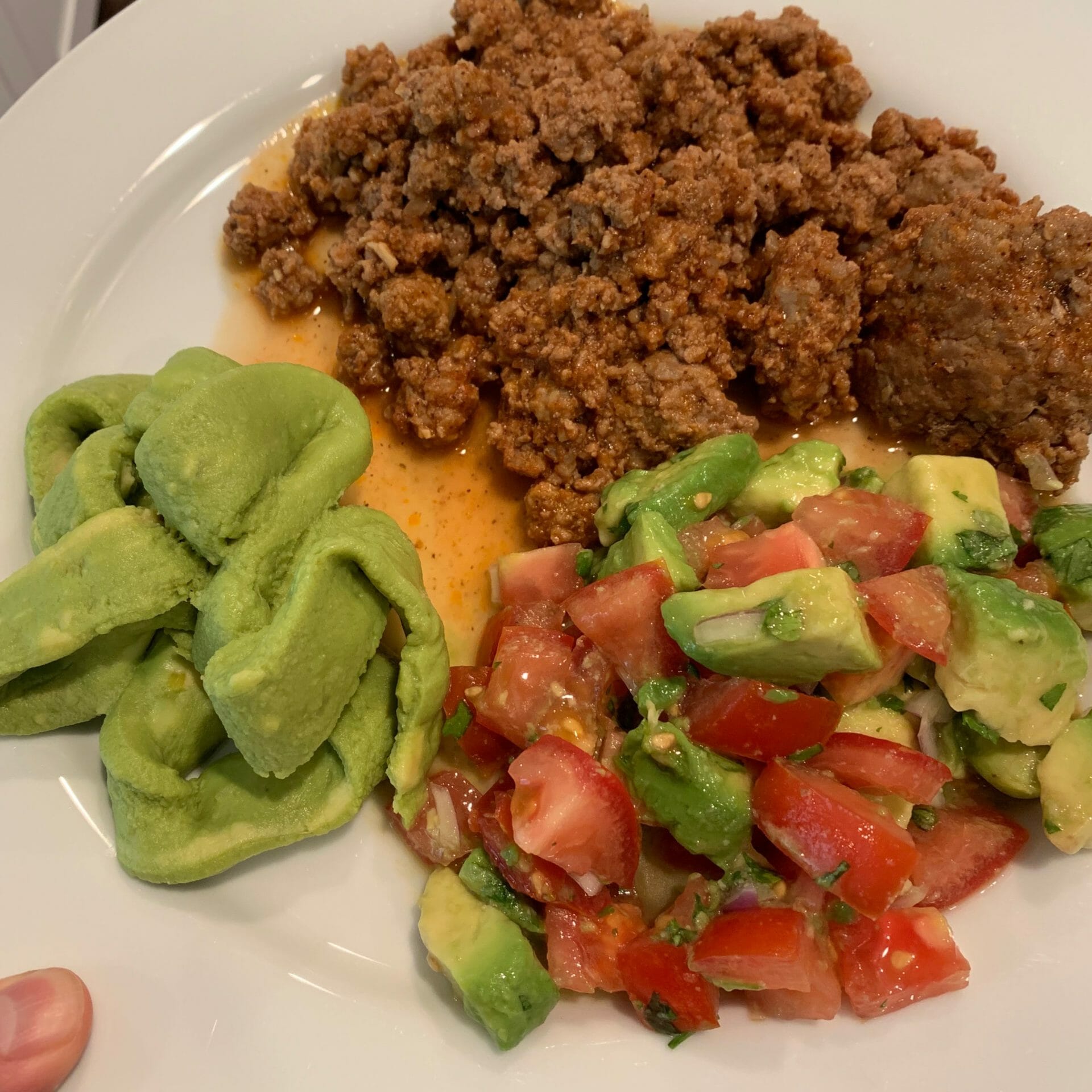 Ground meat with guacamole and avocado/tomato salad