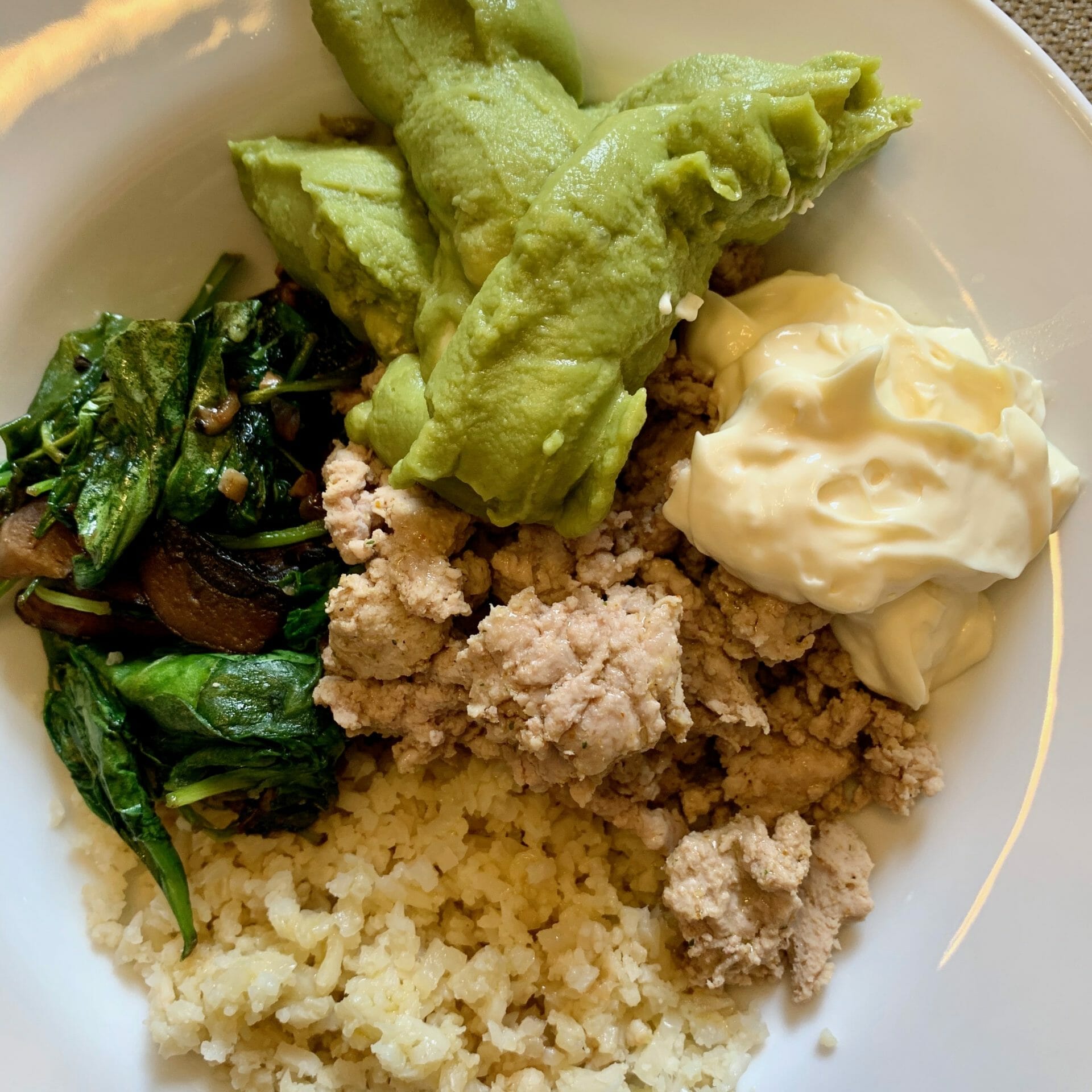 Ground turkey, riced cauliflower, spinach and mushrooms. Topped with mayo and guacamole