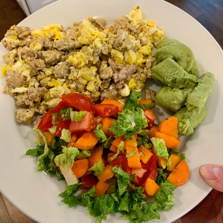 Ground turkey with scrambled eggs, guacamole, lettuce with tomatoes, carrots and peppers