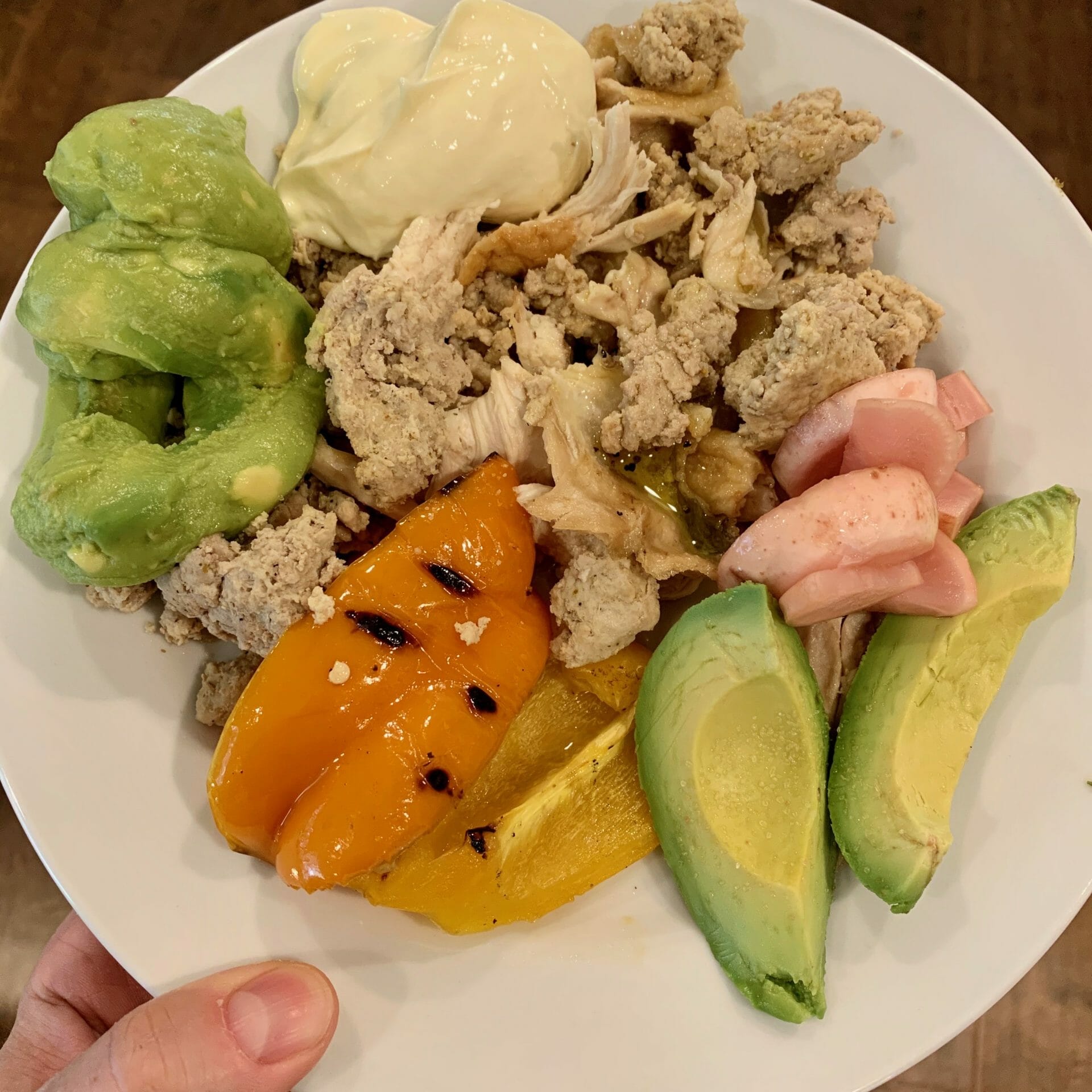 Plate consisting of leftovers: organic rotisserie chicken, ground turkey, grilled peppers, avocado, guacamole and a lot of mayonnaise
