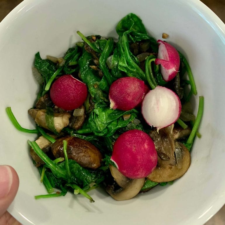 Sautéed spinach and mushrooms with radishes