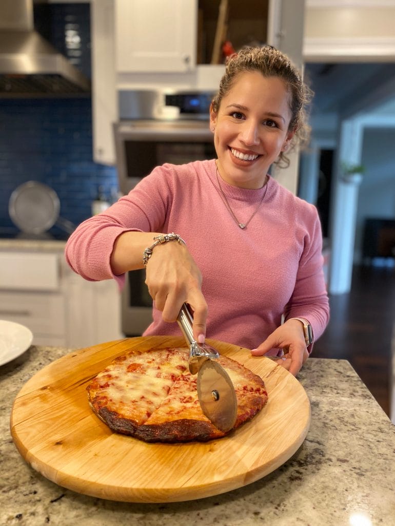 Kathy cutting Califlour pizza smiling - 1