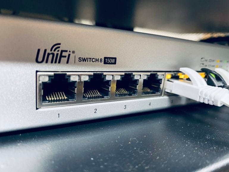 An 8-port UniFi switch provides power over ethernet