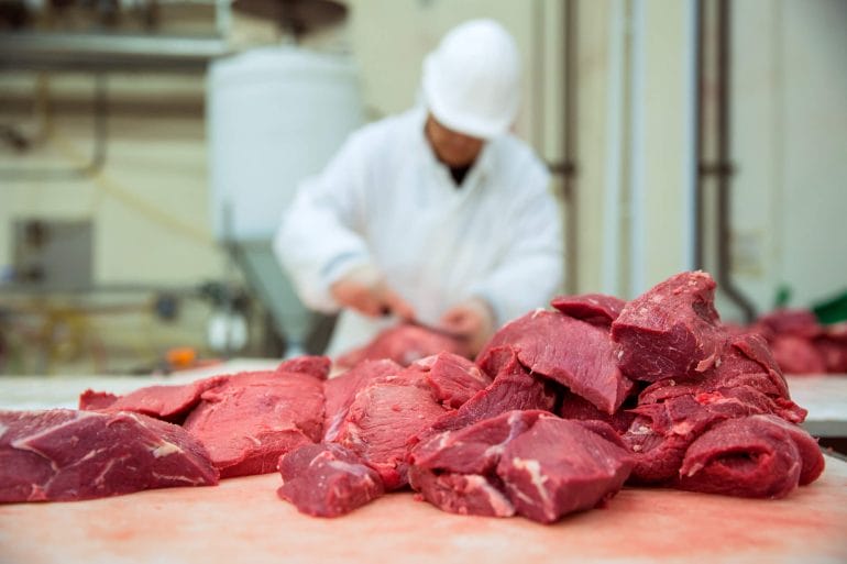 Butcher cutting meat