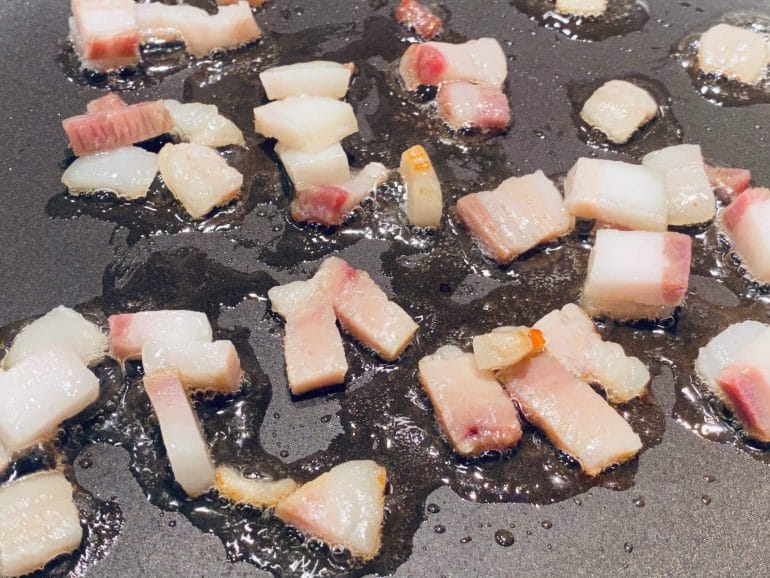 Bacon sizzling in pan