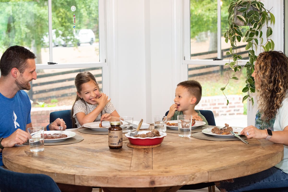 Kummer family having dinner with beef liver capsules in foreground