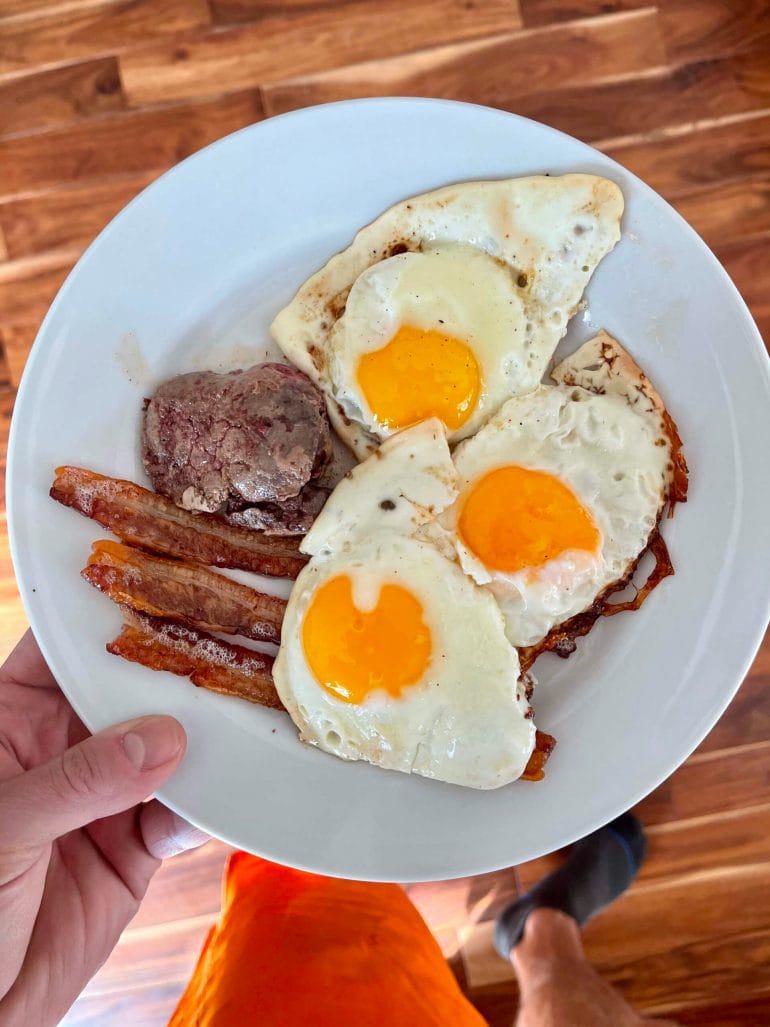 A plate with eggs, bacons and more.