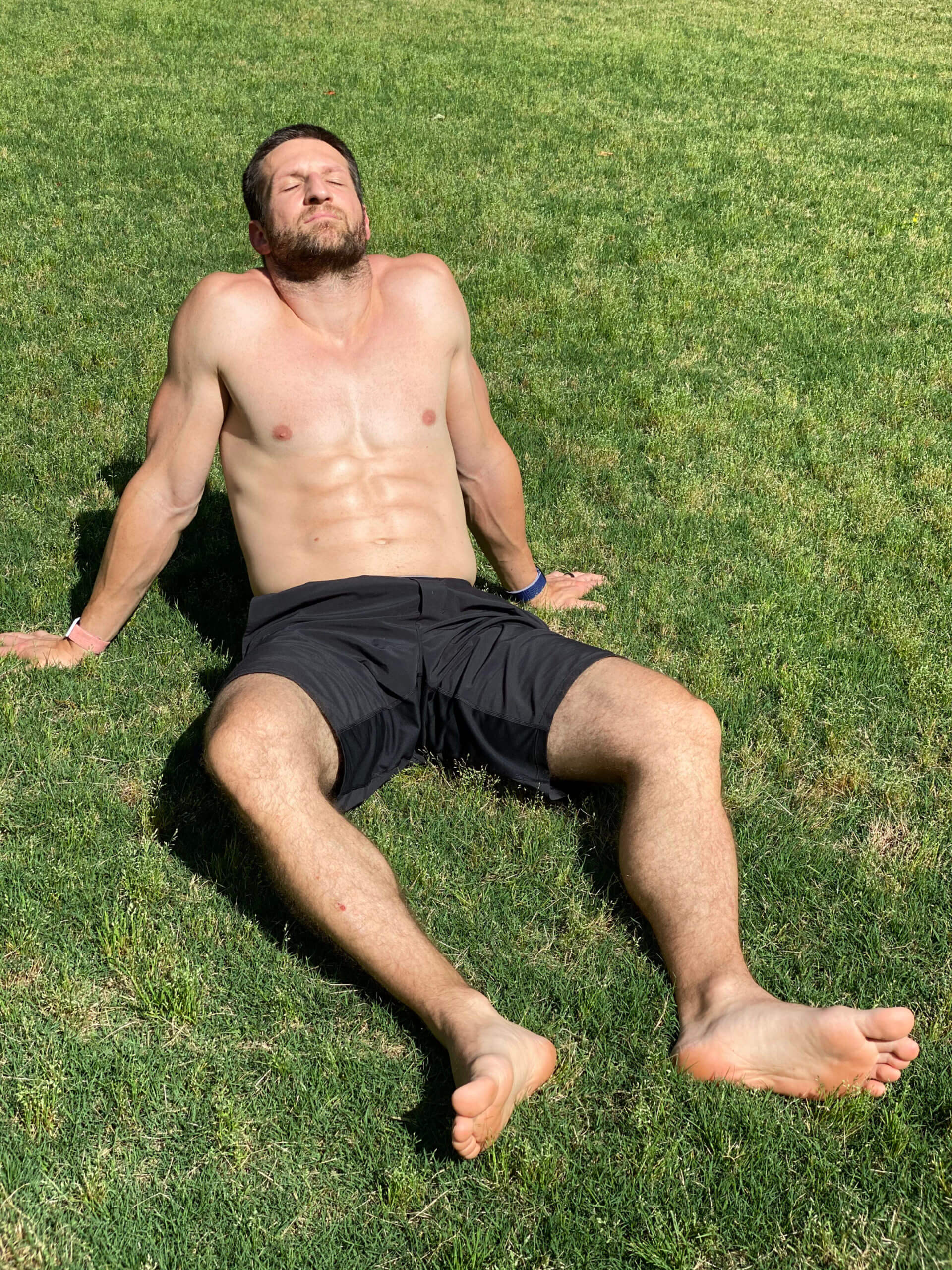 A photo of Michael Kummer sunning shirtless in the backyard.