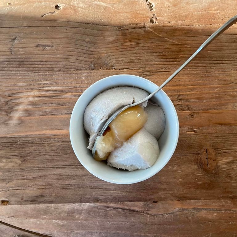 A bowl of coconut milk yogurt with raw honey.
