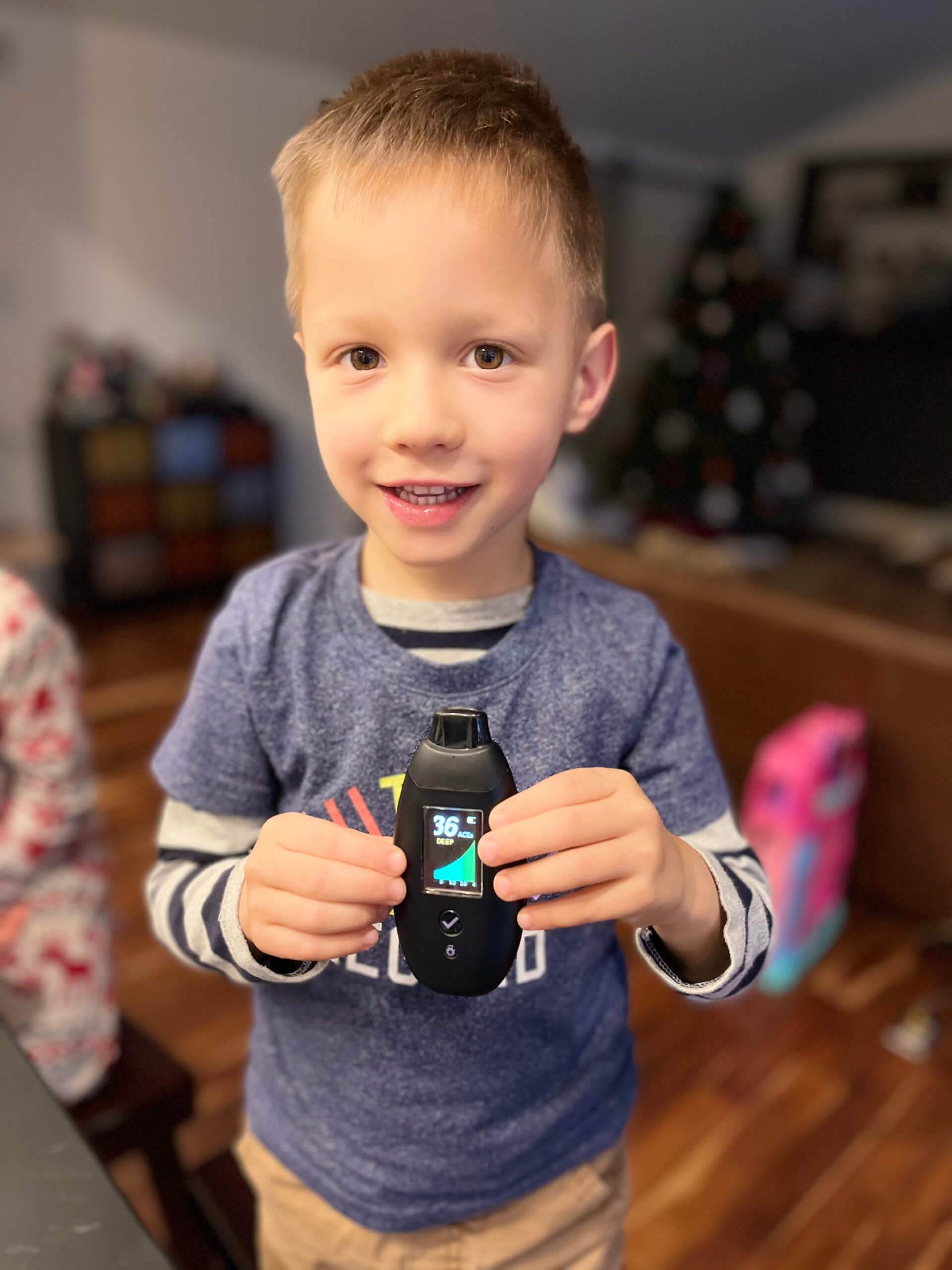 Michael Kummer's son Lucas using a breath ketone reader.