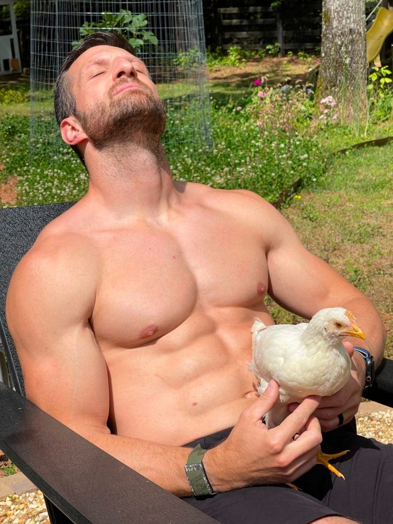Michael Kummer relaxing in a sun with a chicken.