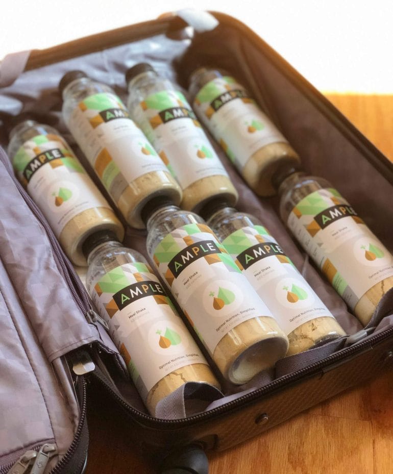 A suitcase filled with bottles of Ample.
