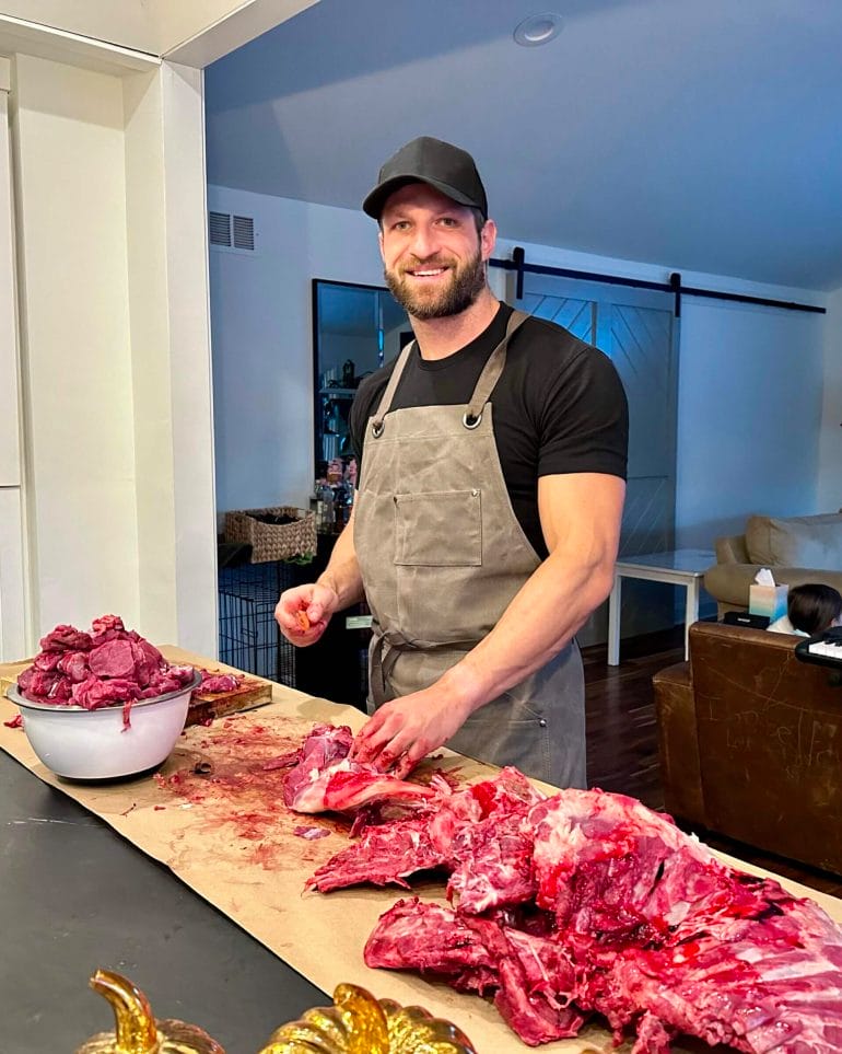 Venison tastes even better when you were the one sourcing and butchering it. The photo shows Michael butchering the first deer he harvested, in November 2022.