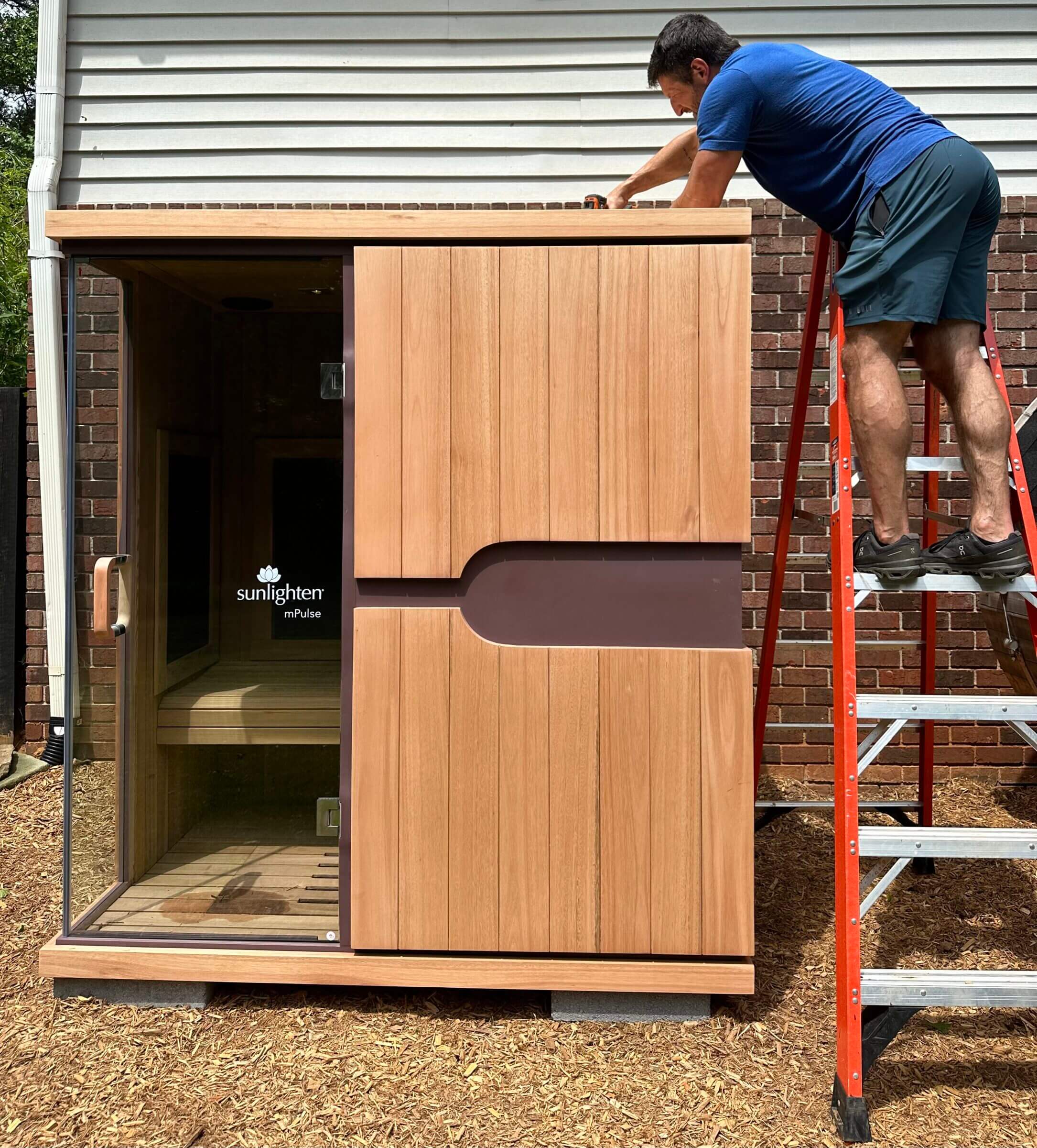 Here I am finishing up the assembly of our walk-in infrared sauna.