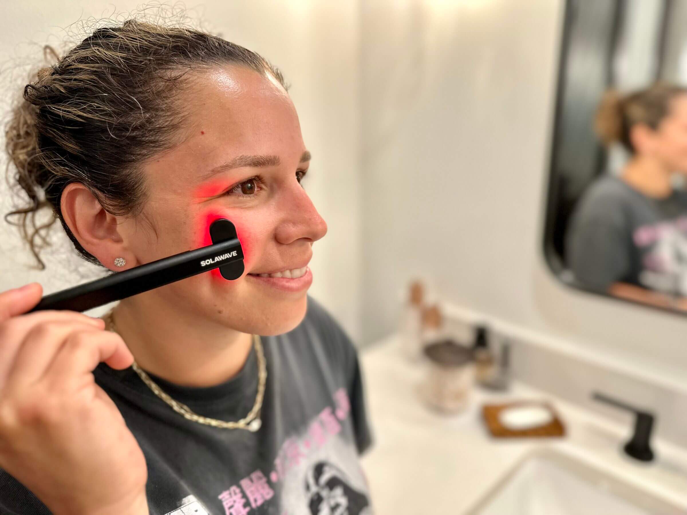 A small wand, like the Solawave my wife Kathy is using in this photo, is the perfect tool to incorporate into your skincare routine.