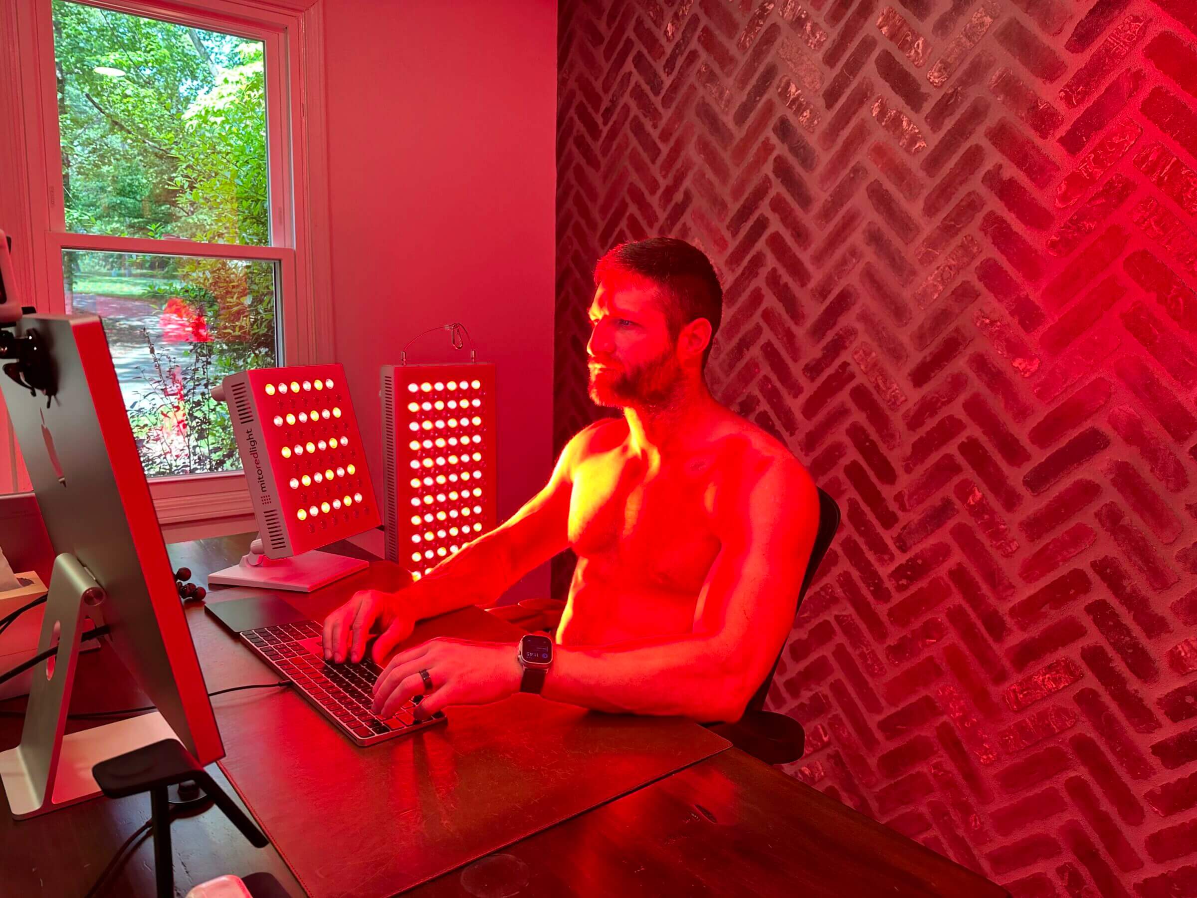 Red light panels — like the Mito panels I'm using in this photo — are great to treat large skin surfaces but aren't effective for treating joints of deep tissue injuries.