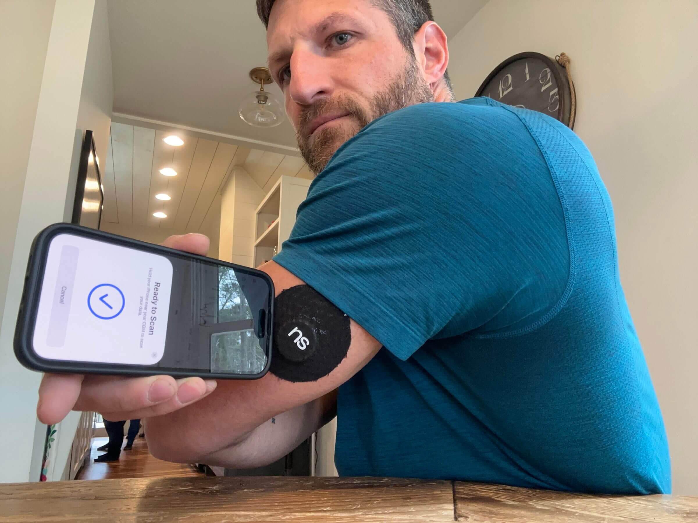 Scanning the sensor using the Nutrisense app requires proper alignment between the NFC antenna on the phone and the CGM.