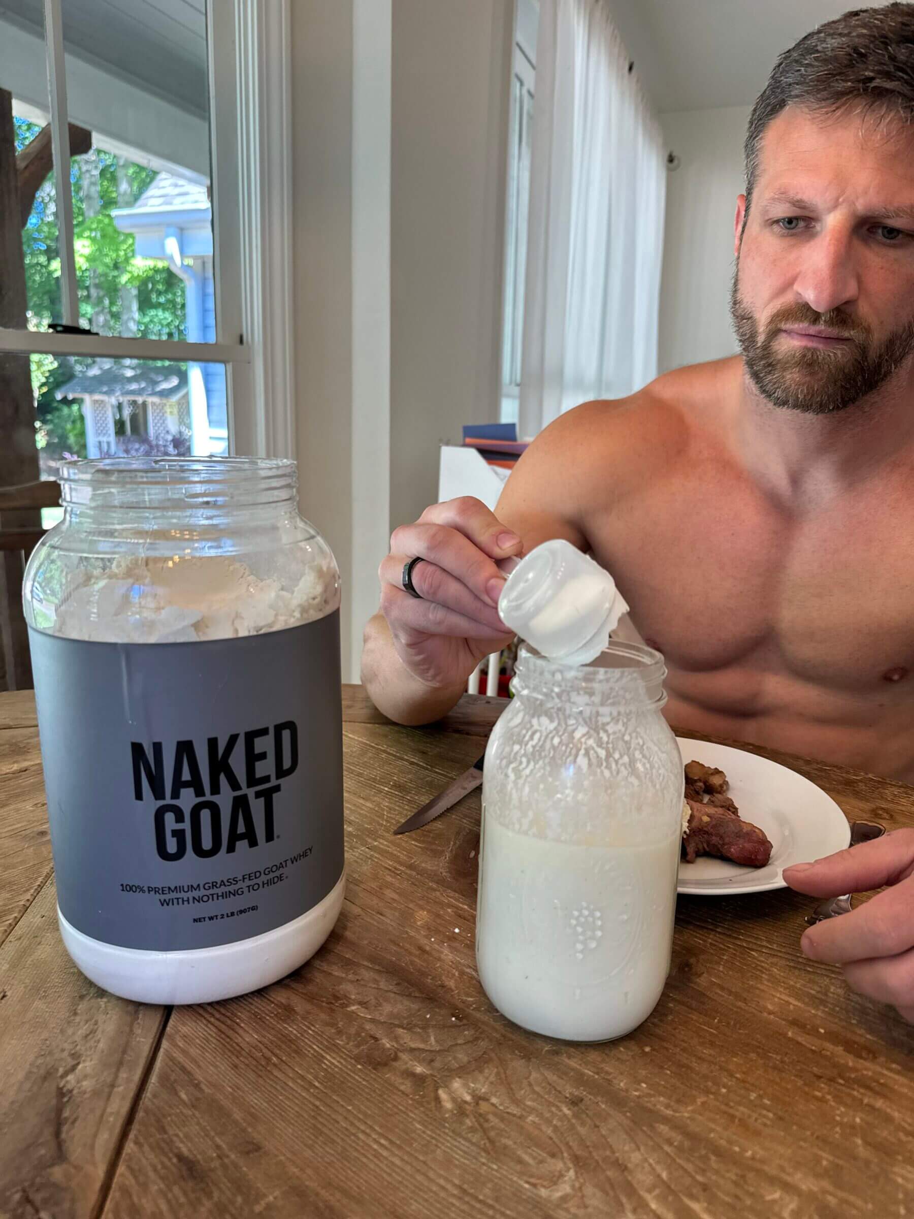 Michael mixing Naked Goat with raw milk.