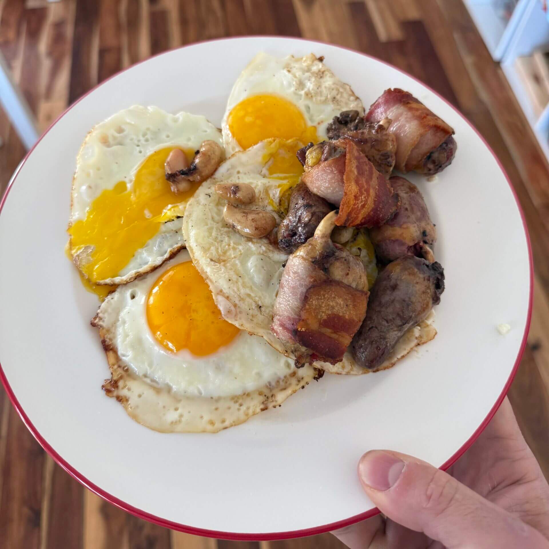 Post-workout meal consisting of eggs, chicken hearts wrapped in bacon and chicken testicles form our homestead