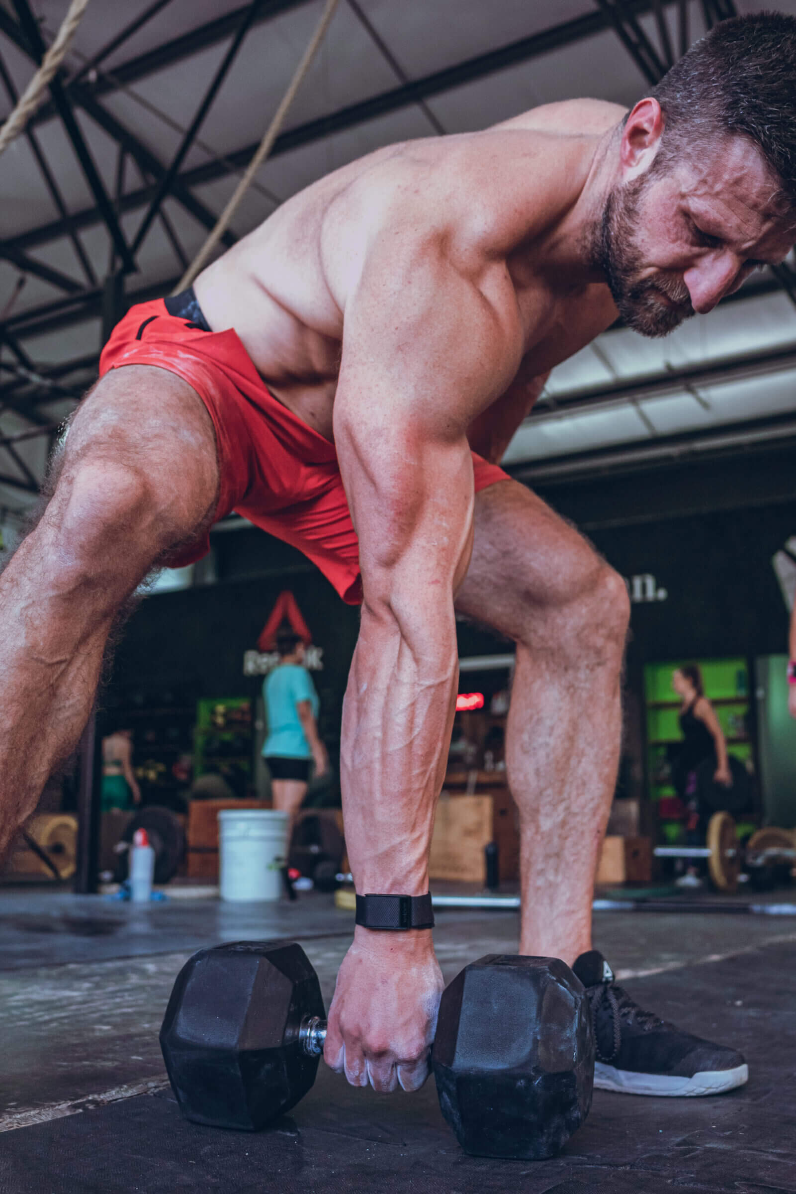 WHOOP (shown here on my wrist) is an excellent tool to keep tabs on how different food choices impact exercise performance and recovery.