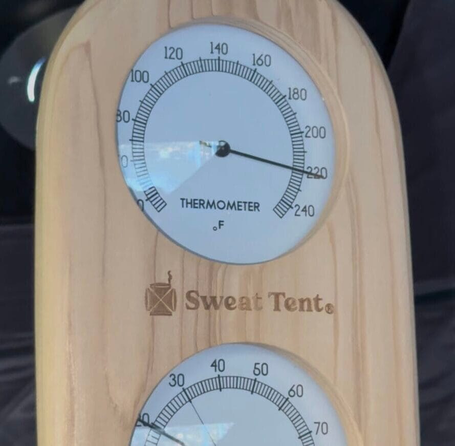 The Sweat Tent sauna's thermometer, showing an internal temperature of 220 degrees.