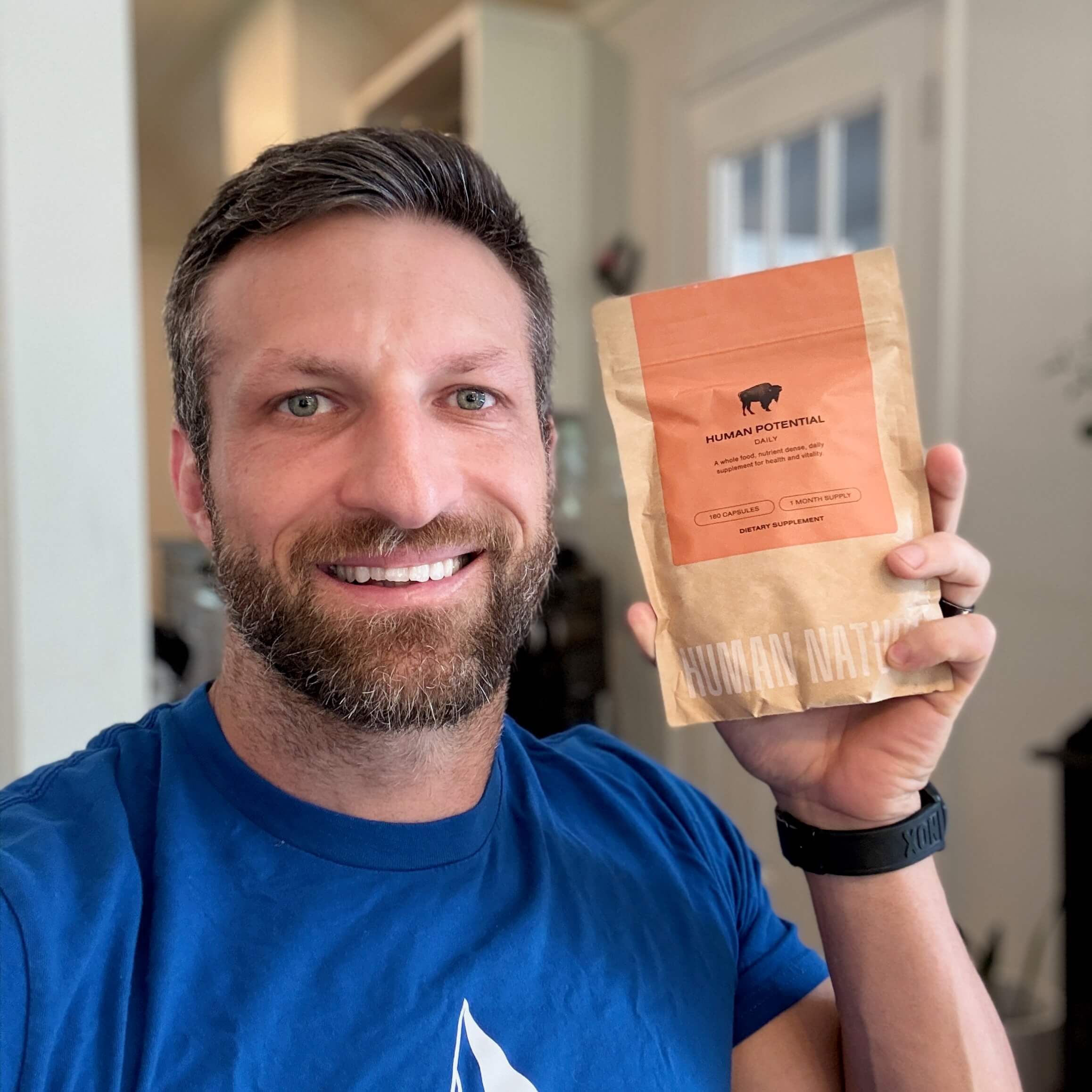 Michael holding a bag of Human Potential bison organ supplements.