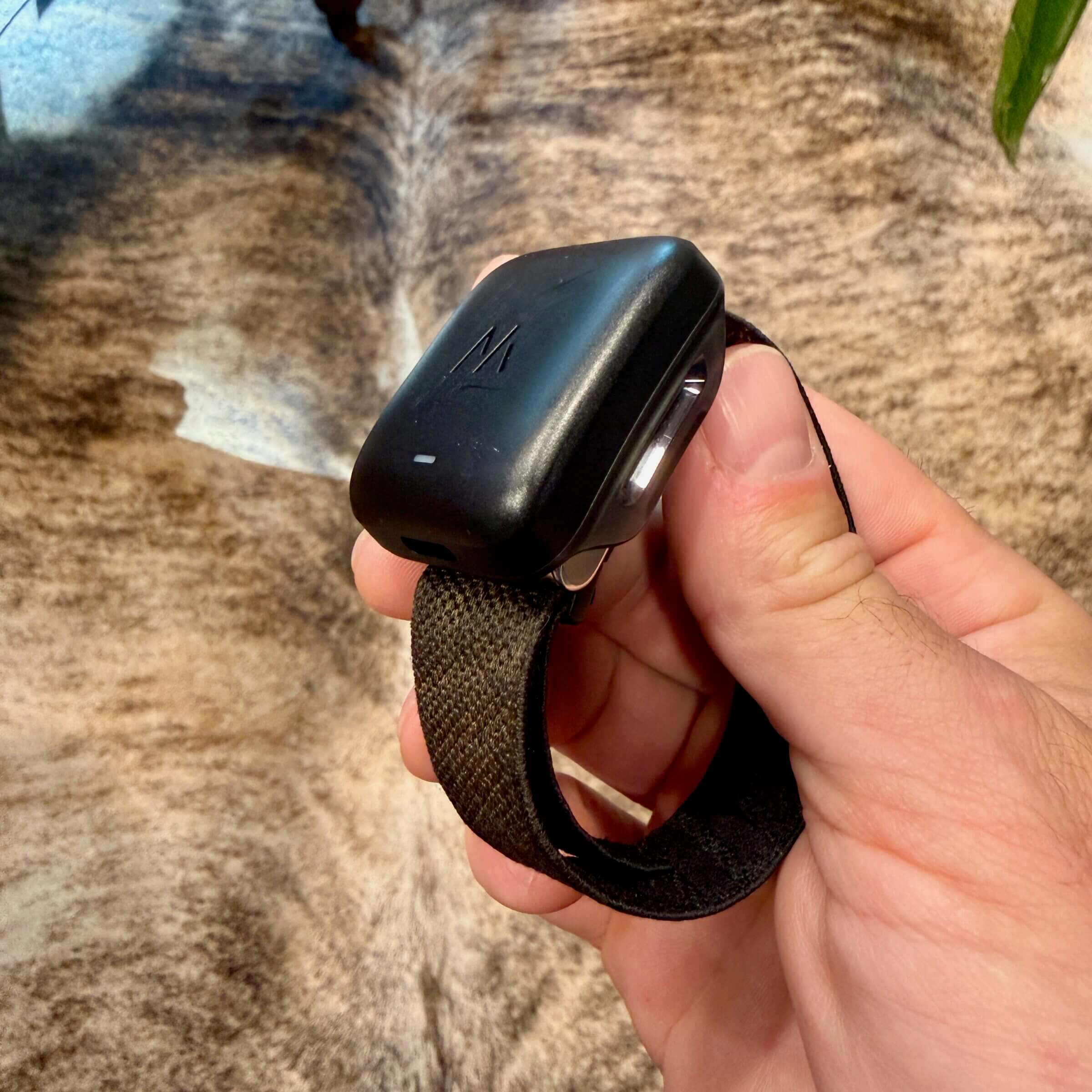 WHOOP with its charging unit attached.