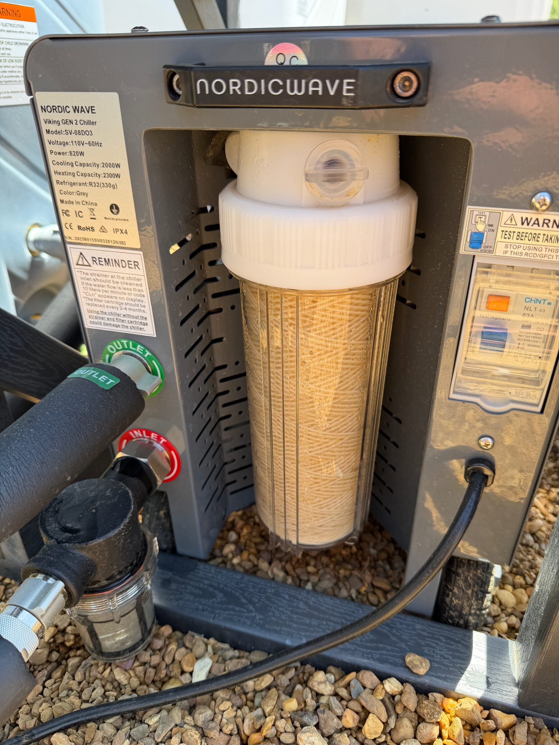 Two stage sediment filter with a clear filter housing and labeled hose connections on the Pro chiller.